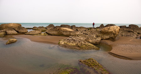 A man on the rocky coast of the Caspian Sea.の写真素材