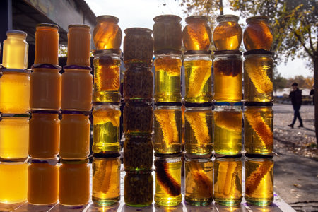 Glass jars filled with different types of honey.の写真素材