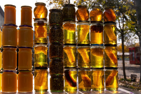 Glass jars filled with different types of honey.の写真素材