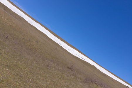 The slope has smooth snow and blue skies.の写真素材