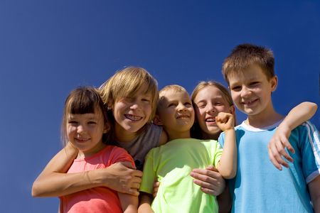 Smiling children on blue skyの写真素材