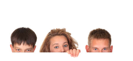 Children looking over sign の写真素材