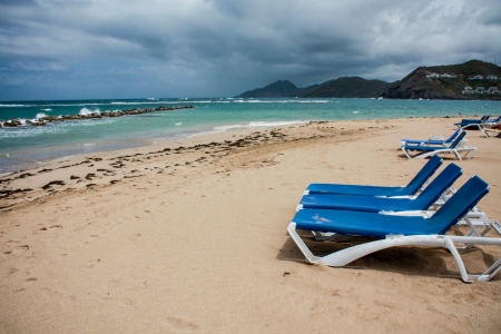 calm beach with deckchairs under the blue skyの写真素材