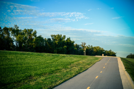 road in the countryside with grass and treesの写真素材