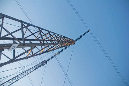 High-voltage post on a background blue sky の写真素材