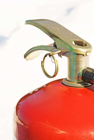 The fire extinguisher on a background of a white snow