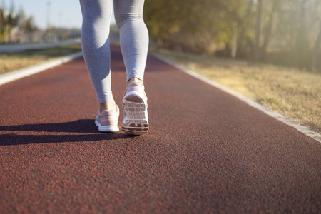 Young fitness woman runner athlete running in city. Woman fitness sunrise jog workout. Healthy lifestyle concept.の写真素材