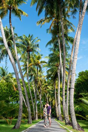 Couple relaxing on a tropical beach at Maldives. Romantic couple having fun on the beach. Summer vacation concept, lifestyle concept. Love and relationship.の写真素材