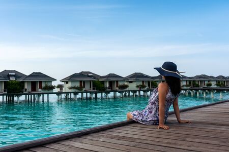 Portrait of young brunette relaxing on the beach. Beautiful fit girl on travel vacation. Attractive girl on tropical beach.の写真素材