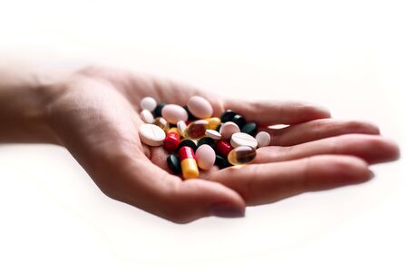 Close-up view of capsule in woman's hand. Pharmaceutical industry.の写真素材