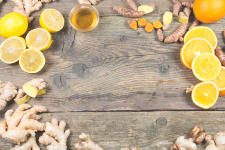 Ingredients for ginger shot recipe. Immunity boosting components for ginger drink. On the old wooden...