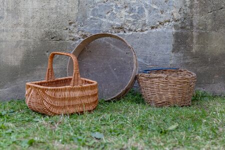 wicker baskets on the grass near the concrete wall