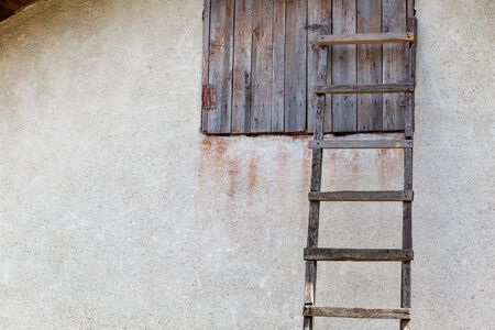old wooden staircase near wall with wooden windowの写真素材