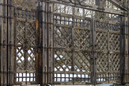 wooden gate with metal fastenings and metal ancient locksの写真素材