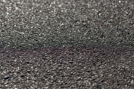 texture of asphalt closeup on a sunny dayの写真素材
