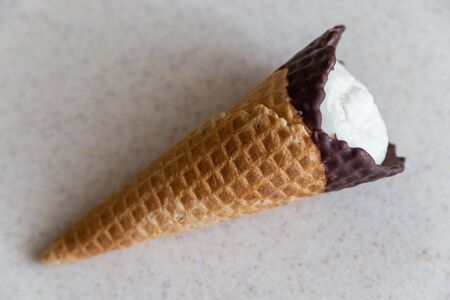 vanilla ice cream in waffle cone isolated on light backgroundの写真素材