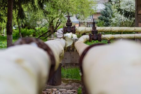 the pipes of the thermal power station passing above the groundの写真素材