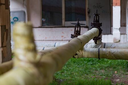 the pipes of the thermal power station passing above the groundの写真素材