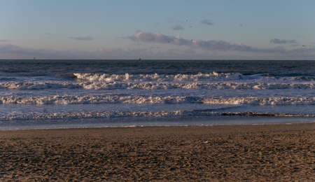 sea waves at sunset in the north sea in the Netherlandsの写真素材