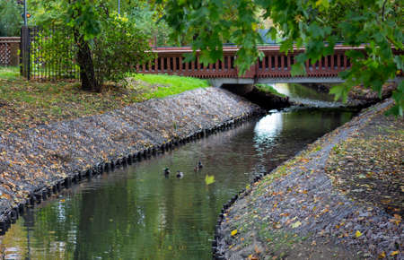 canal with water brick bridge in the parkの写真素材