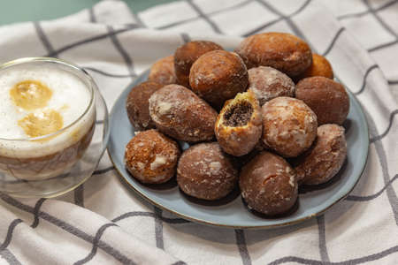donuts with poppy seeds and cappuccino in a glassの写真素材