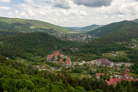 Panorama top view of the city of Yaremche Ukraine between the mountains and clouds in summerの写真素材