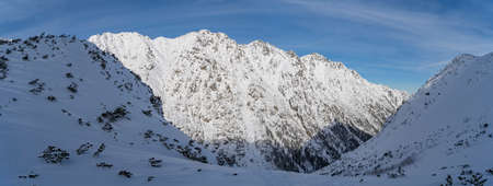Mountain winter landscape in the Tatras, trail trampled in the snow overlooking the snow-capped mountains in frosty sunny weather Tatras Polandの写真素材
