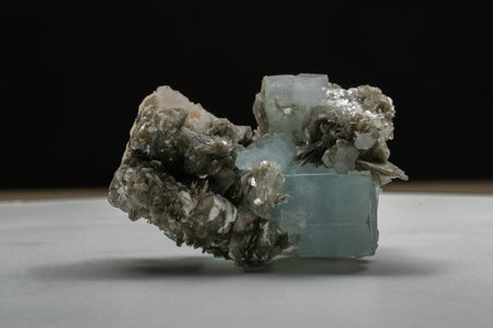 blue crystal with beautiful metallized crystals on a light plane black background isolated crystal from a cave studio light beautifully shows the structure of the crystalの写真素材