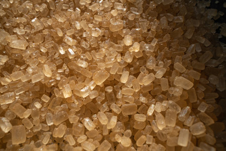 granules of brown sugar macro on a black backgroundの写真素材
