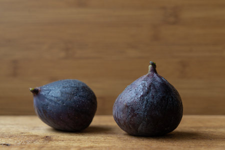 two figs close up on a wooden surfaceの写真素材