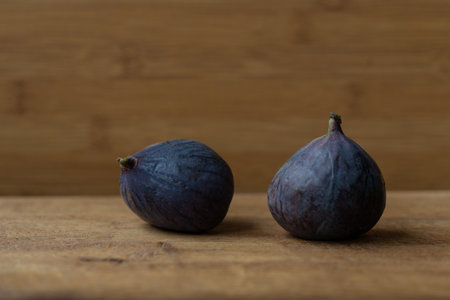 two figs close up on a wooden surfaceの写真素材