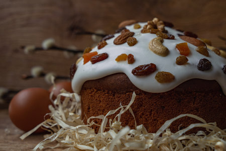 Easter cake with raisins and nuts on a wooden backgroundの写真素材
