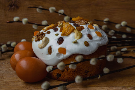 Easter cake with raisins and nuts on a wooden backgroundの写真素材