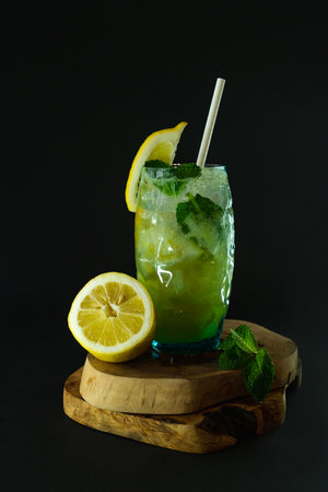 Mojito cocktail with lemon, mint and ice on black backgroundの写真素材