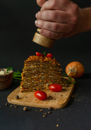Liver cake with carrots, vegetables and spices on a wooden board.の写真素材