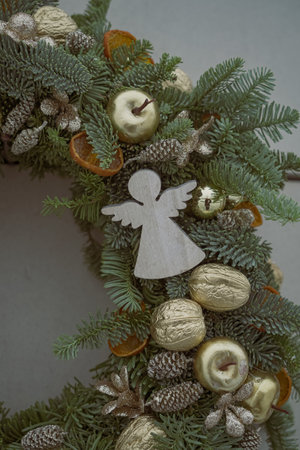 christmas wreath decoration with angel and ornaments on gray backgroundの写真素材