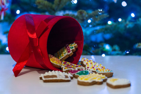 Christmas cookies in a red gift box on the background of a Christmas treeの写真素材