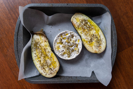 Baked eggplants with cheese and spices in a baking trayの写真素材