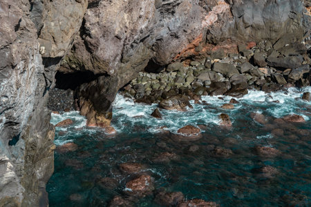 Beautiful seascape with pebble beach and sea waves of Madeira, Portugalの写真素材