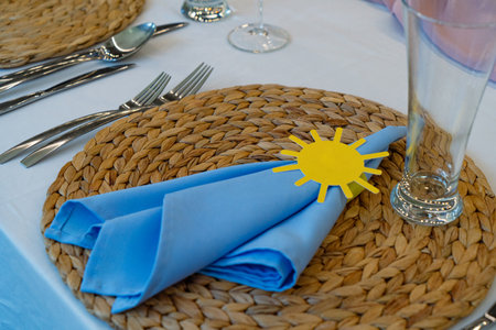 Table setting with blue napkins and cutlery on the tableの写真素材