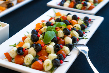 Caprese salad with mozzarella cheese, olives and basilの写真素材