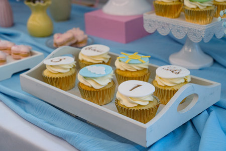 Cupcakes decorated with buttercream frosting on a buffet tableの写真素材
