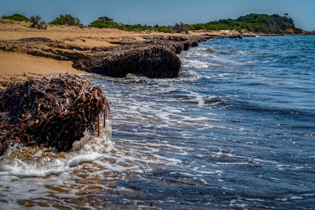 Beautiful seascape with rocks, sea waves and blue sky on Korfu Greeceの写真素材