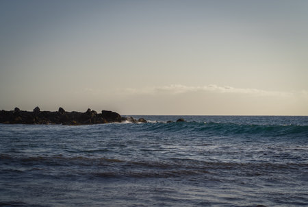 Waves breaking on the rocks in the evening.の写真素材