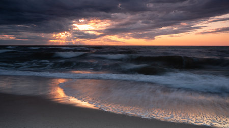 Sunset on the beach of the Baltic Sea in Ustka, Polandの写真素材