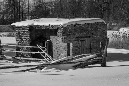 Abandoned building in the snow. Black and white photo.の写真素材