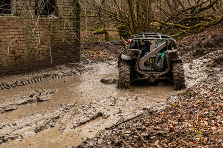 Racing off-road vehicle on a muddy road in the forestの写真素材