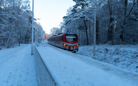 Train on the road in the winter forest, closeup of photoの写真素材