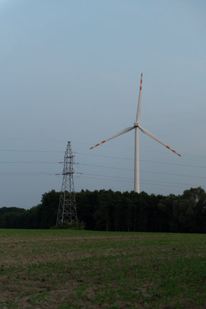 An image of windturbine in the field with blue skyの写真素材