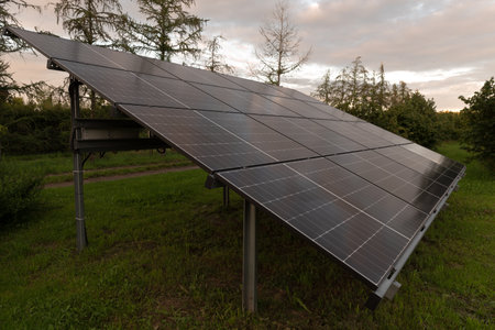 Solar panels installed on the roof of a house in the forest.の写真素材